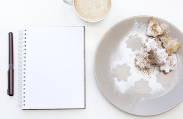 Mockup with blank notepad, cup of coffee and biscuit. New year cookies and cappuccino. Christmas morning still life.