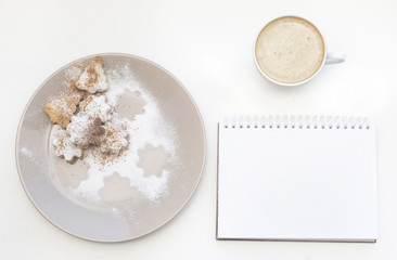Mockup with blank notepad, cup of coffee and biscuit. New year cookies and cappuccino. Christmas morning still life.