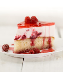 Slice of vanilla sponge cake with yogurt souffle and raspberry jelly. Sweet food for holiday