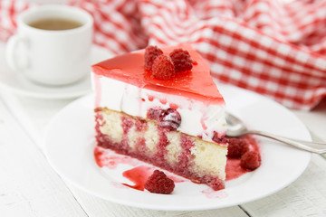 Slice of vanilla sponge cake with yogurt souffle and raspberry jelly. Sweet food for holiday