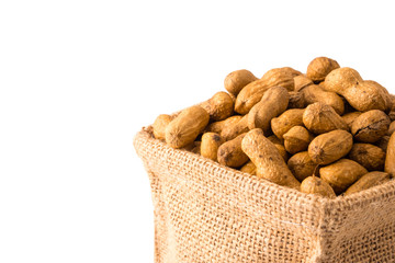 Peanuts in burlap bag on white background.