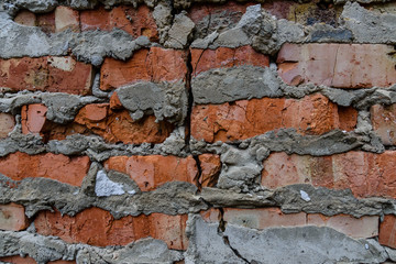 Detail of the cracked red bricks wall