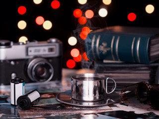 A mug on old photos. in the background of an old camera and photo albums.