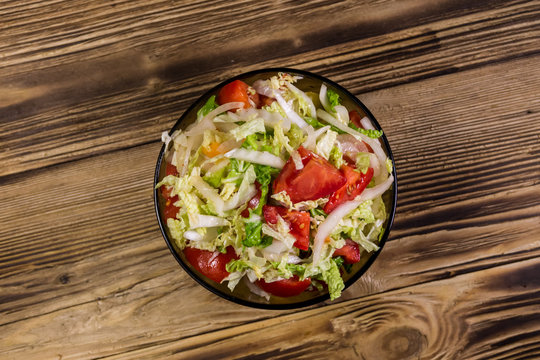 Fresh vegetable salad on wooden table
