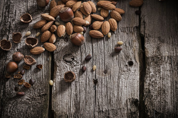 Mixed nuts on old wooden background