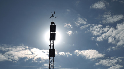 Fototapeta premium Solar panel and wind turbine on the sky background .