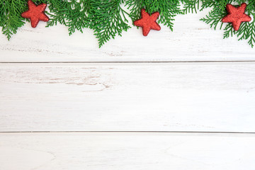 The Pine leaf with red star and christmas ball decoration on a white wooden board with copy space , happy new year and chistmas festival background concept