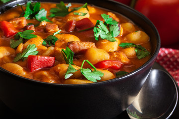 White bean soup with potatoes, tomatoes, paprika, and bacon