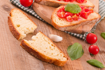 Bruschetta bread with basil and chopped tomatoes.