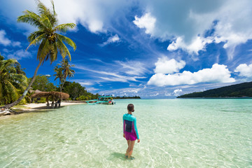 Beach vacation tourist woman swimming in French Polynesia island on cruise excursion at Huahine...