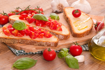 Bruschetta bread with basil and chopped tomatoes.