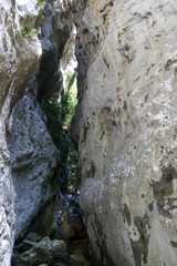 Fototapeta na wymiar hiker in narrow gorge canyon at matese park valle del torano