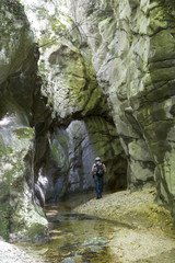 hiker in narrow gorge canyon at matese park valle del torano