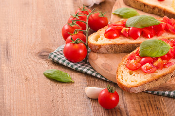 Fototapeta na wymiar Bruschetta bread with basil and chopped tomatoes.