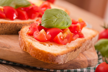 Bruschetta bread with basil and chopped tomatoes.