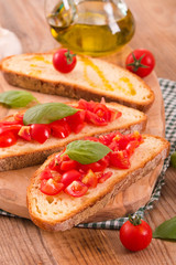 Bruschetta bread with basil and chopped tomatoes.