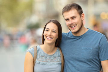 Fototapeta premium Front view of a couple walking on the street