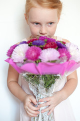 Girl with a bouquet in hands of the birthday