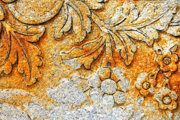 Vintage Thai Sculpture on Stone Wall.