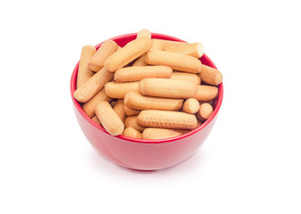 Cookies in the form of sticks in a red bowl