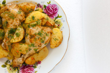 Barbecued chicken leg with boiled potatoes .