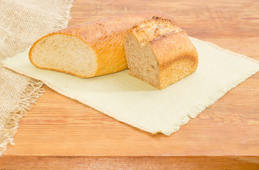 Two halves of different wheat sourdough bread on a napkin