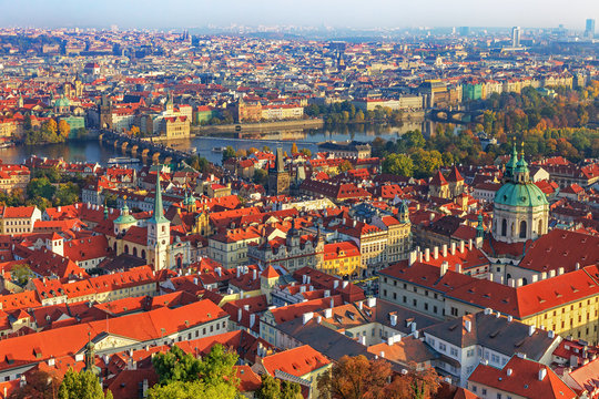 Scenic view on Charles bridge, Vltava riever and the red roofes of Prague from the belltower of the Cathedral of Saints Vitus