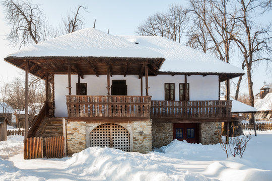 Front view of an old traditional Romanian house in winter.