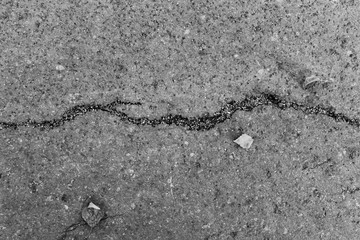 background and texture of asphalt with a crack