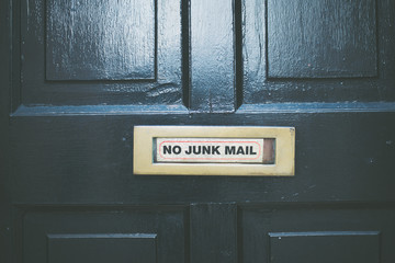 No Junk mail sign on a black door plate