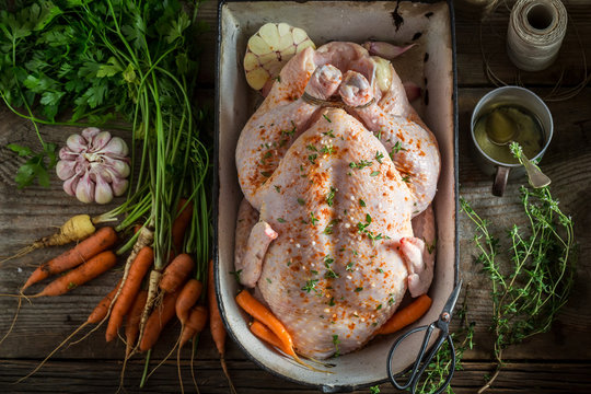 Preparation for grilled homemade chicken with garlic and carrots