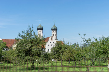 Fototapeta na wymiar monastery Benedickbeuern / Fruit trees in front of Benedictbeuern monastery in Bavaria, Germany