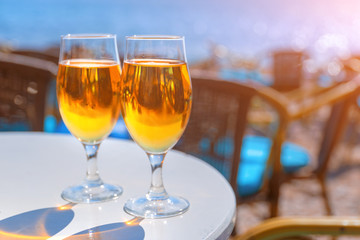 Two glasses with beer on a round table