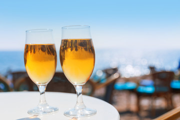 Two glasses with beer on a round table