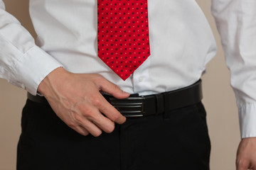 Businessman held Buckle to look good as smart man concept.