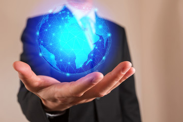 Businessman hand hold, light blue circular digital world with mesh line networking as business, controller, technology cyber and globalization concept.