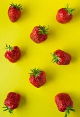 Obraz na płótnie Canvas Bright fresh strawberry closeup on yellow background
