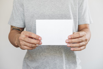 Close-up a man holding blank white paper