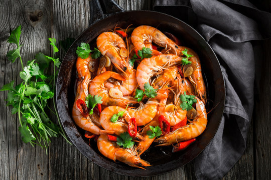 Spicy shrimps on pan with parsley and garlic