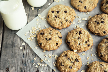 homemade oatmeal cookies with chocolate on an old wooden background