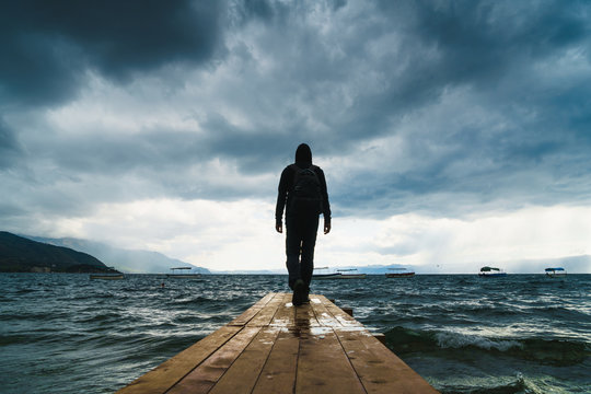 Anonymous man posing on pier