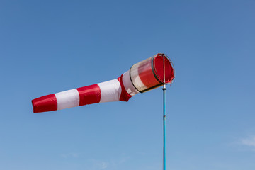 Airport windsock on clear blue sky background in windy weather indicate the local wind direction,air sock, drogue, wind sleeve, wind cone