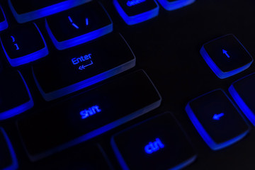 black keyboard with blew lightning, dark image, shallow depth of field