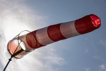Airport windsock on clear blue sky background in windy weather indicate the local wind...