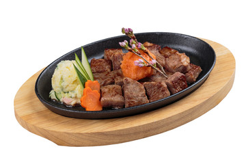 Isolated medium rare wagyu steak topping with mince carrot on hot plate and wooden plate served...