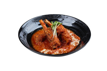 Isolated Pork rib chops steaks boiled with tomato sauce and cheese served in black round plate.
