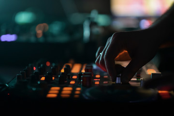 DJ mixer disco illuminated by searchlights