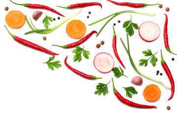 mix red hot chili peppers with parsley and sliced cucumber and carrot isolated on white background top view