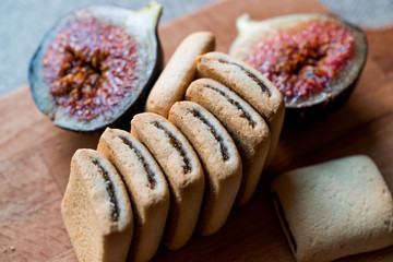 Fig Cookies with fruits on wooden surface.