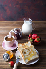 Breakfast with coffee, toasts, strawberry and jam